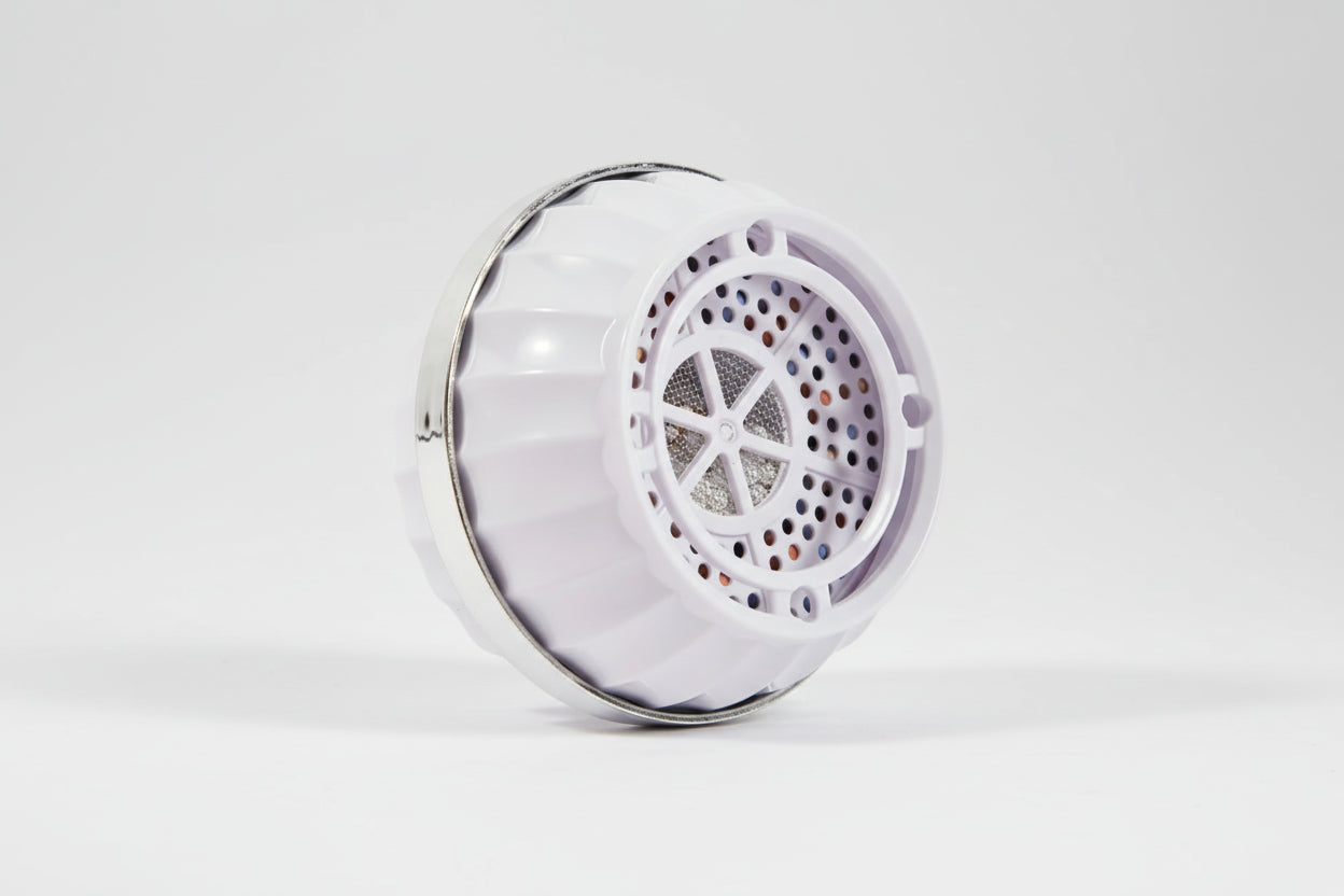 Premium bathtub water filter laying on its side on a studio background